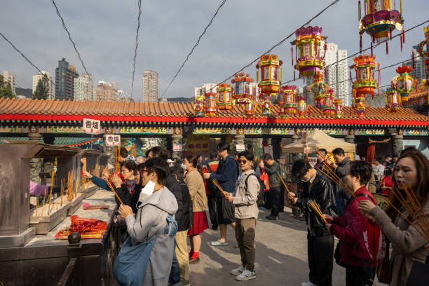 Hong Kong - February 10, 2025 : People at the Wong Tai Sin Temple, Kowloon, Hong Kong. It is a Taoist temple established in 1921. Wong Tai Sin Temple is one of the most famous temples in Hong Kong.