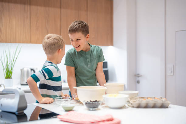 istock Joyful Caucasian Brothers Baking Cookies at Home 2198834733