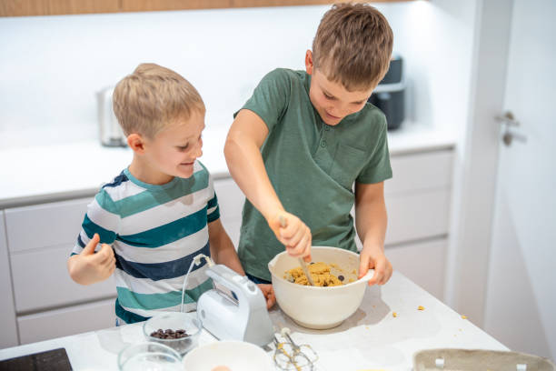 istock Joyful Caucasian Brothers Baking Cookies Together 2198834774