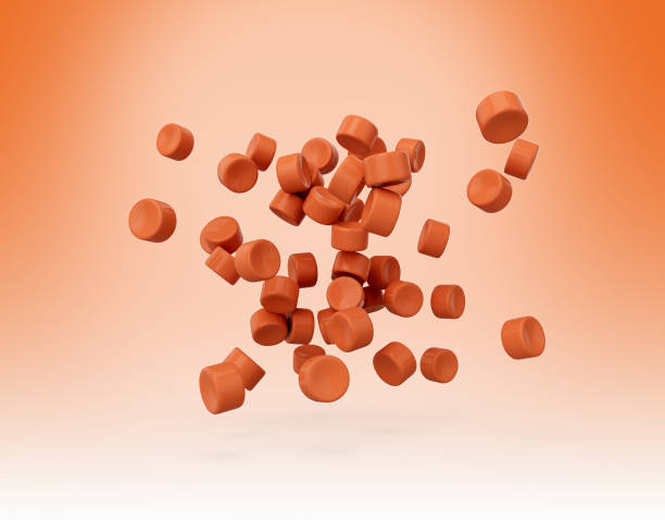 istock Orange Plastic Pellets Or PVC Polymer Beads Falling On Soft Coral Background 3d Illustration 2198835018