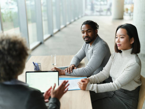 istock Diverse couple having a meeting with their agent in the office. 2198836513
