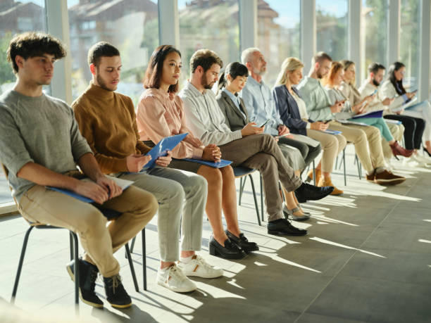 istock Group of candidates waiting for job interview in a hallway. 2198836562