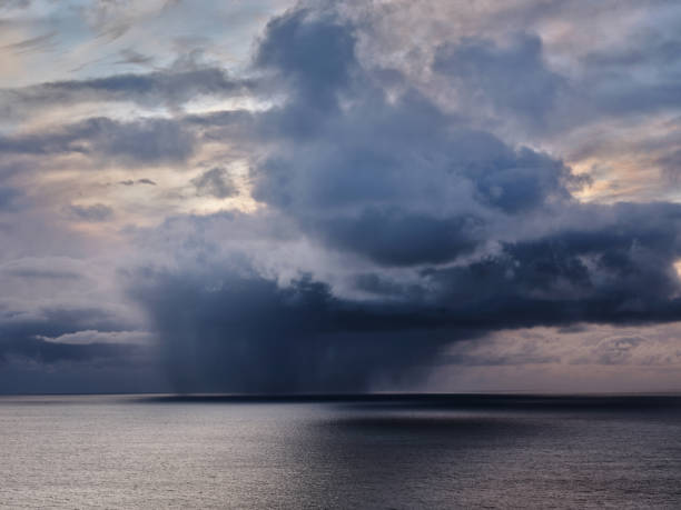 View of the cumulonimbus clouds above the sea at Faroe Islands. Photographed in medium format.
