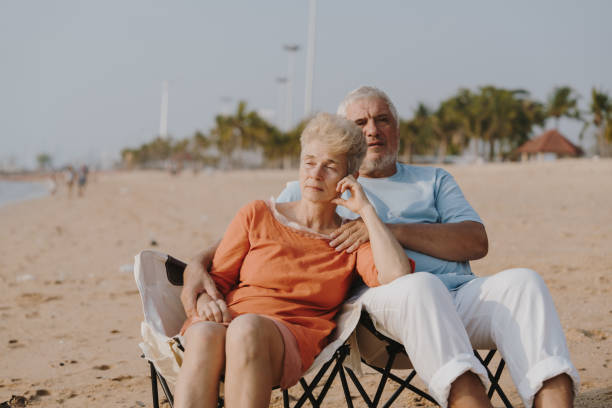 istock Elderly couple enjoys a happy beach holiday 2198838988