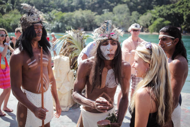 Varadero, Cuba - March 11, 2024: Performers in traditional attire interact with tourists near the water, showcasing Cubas rich cultural heritage and history.