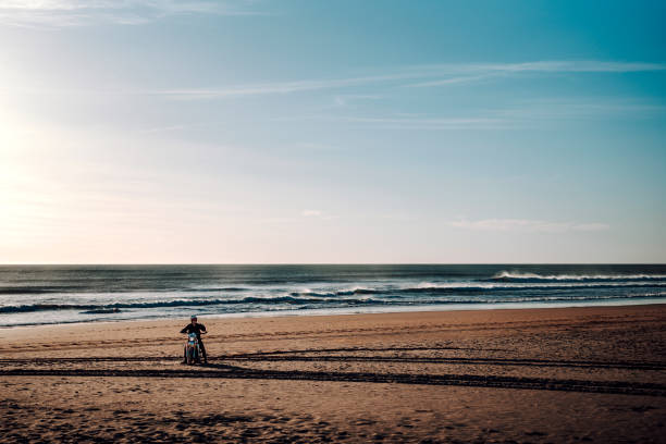 istock Man on motorcycle at the beach 2198840811