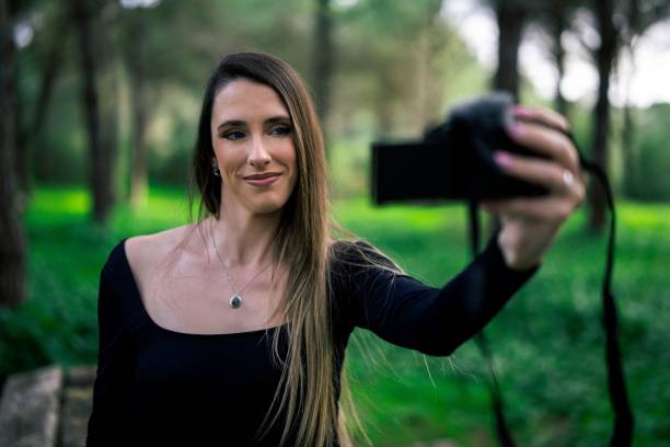 istock Woman capturing a selfie in a forest setting. 2198840907