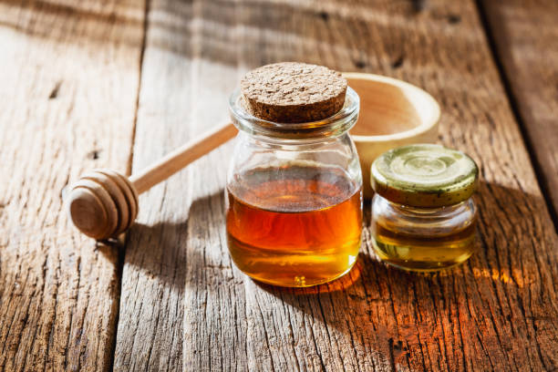 istock honey with dipper on wooden background 2198840947