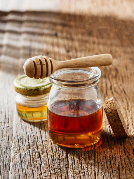 istock honey with dipper on wooden background 2198840982