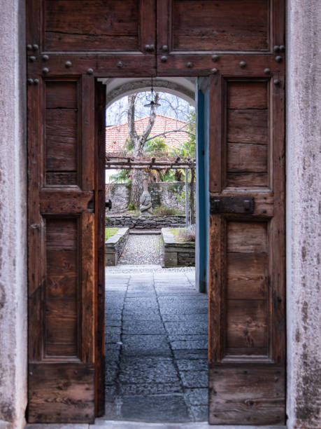 istock Rustic doorway leading to a garden with benches 2198840996