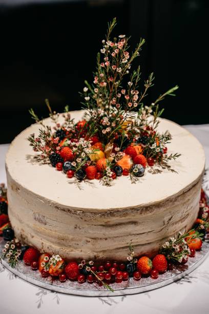 istock Elegant naked cake with berries and flowers. 2198841395