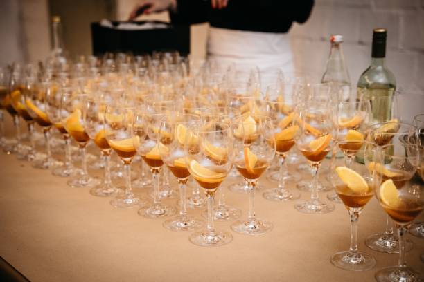 istock Wine glasses with orange slices on a long table 2198841434