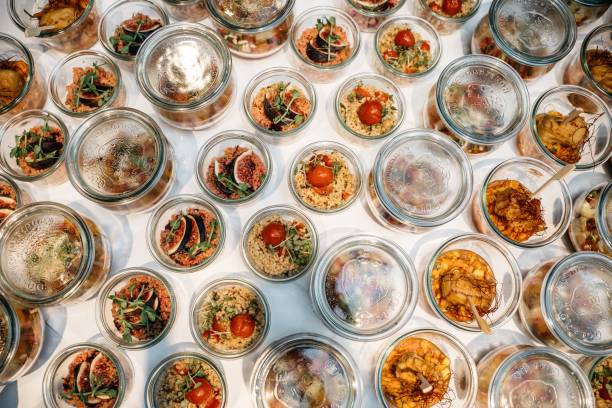 Assorted gourmet dishes in glass jars.