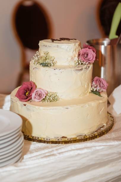 istock Wedding cake with pink roses and white flowers. 2198841609