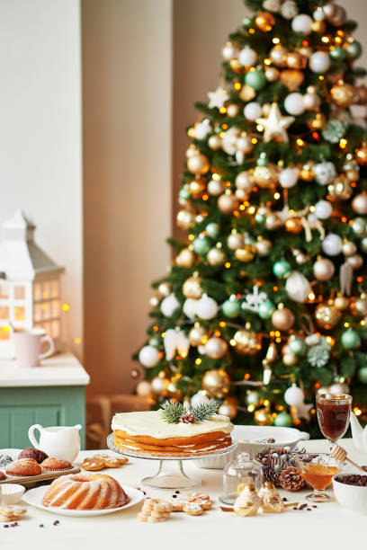istock Christmas cake and sweets on table. Christmas decorations with lights background. Happy New Year! Christmas greeting card. Winter card template. Xmas concept. Holiday Banner. Feast of Nativity. 2198845007