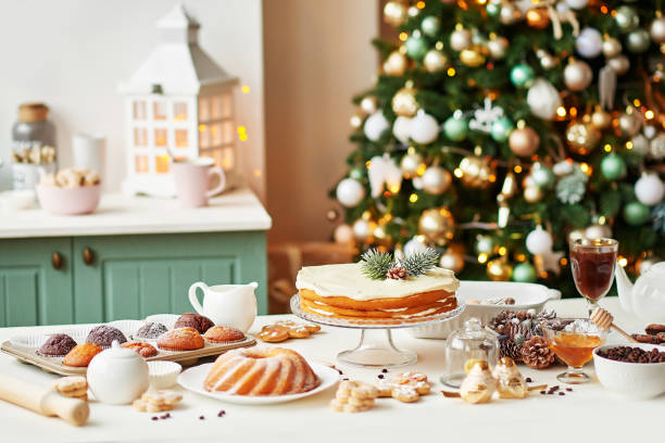 istock Christmas cake and sweets on table. Christmas decorations with lights background. Happy New Year! Christmas greeting card. Winter card template. Xmas concept. Holiday Banner. Feast of Nativity. 2198845027