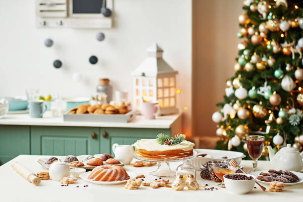 istock Christmas cake and sweets on table. Christmas decorations with lights background. Happy New Year! Christmas greeting card. Winter card template. Xmas concept. Holiday Banner. Feast of Nativity. 2198845044