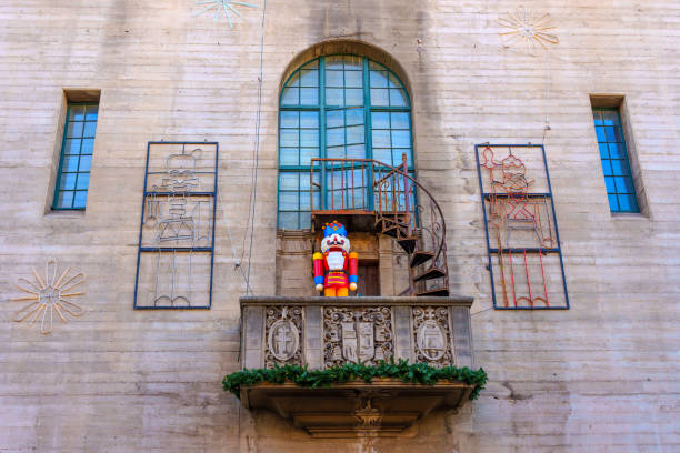 Riverside, California - December 31, 2024: Close-up view of a balcony at the Mission Inn in Riverside, California, featuring a festive guard figure surrounded by holiday decorations and architectural details.