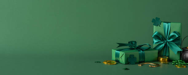 istock Green gift boxes with St. Patrick's Day side view themes, featuring shamrocks and gold coins in a celebratory composition 2198847672