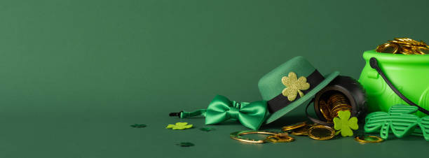 istock Festive side view St. Patrick's Day display featuring a green hat, pot of gold, and shamrocks 2198847708