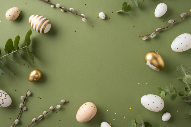 istock Elegant arrangement featuring Easter eggs, greenery, and twigs on a stylish green surface 2198847727