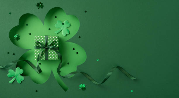 istock A vibrant St. Patrick's Day design featuring a green backdrop, clover shapes, and a ribboned gift box. Perfect imagery for festive greetings, holiday decorations, or themed celebrations. 2198847728