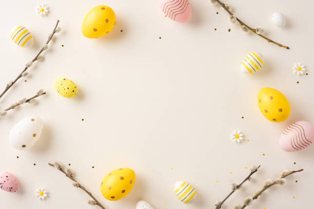 istock Colorfully decorated Easter eggs arranged with small flowers and branches on a pastel surface 2198847740