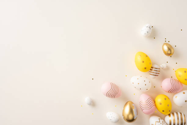 istock Colorful painted Easter eggs in pastel tones scattered over a soft beige background for festive decoration 2198847766
