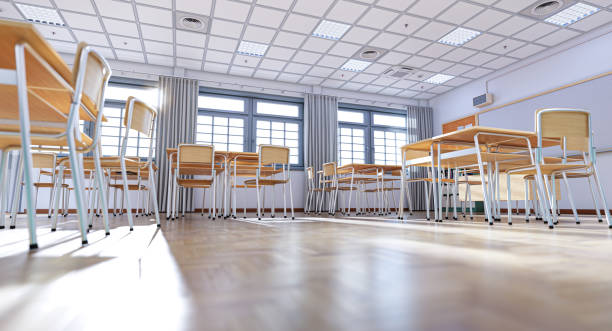 istock Empty classroom with wooden desks and chairs waiting for students 2198848888