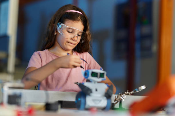 istock Little scientist working with a robot in laboratory. 2198849210