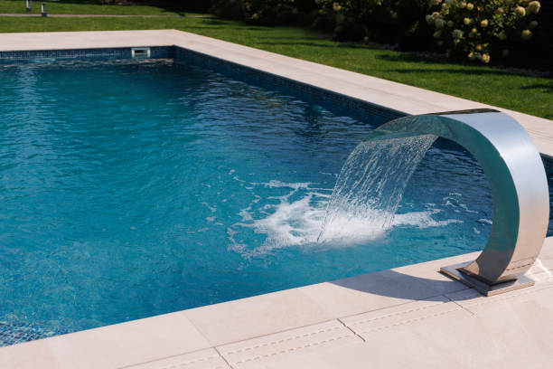 istock Luxury outdoor swimming pool with a modern stainless steel waterfall feature, creating a refreshing and elegant summer vibe. 2198849261