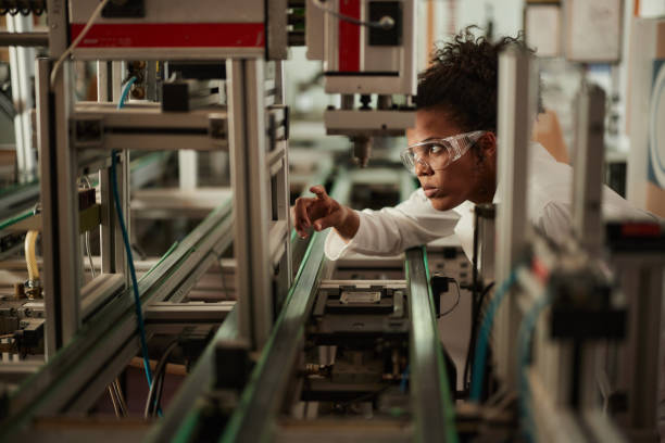 istock Young black scientist working on machinery in a lab. 2198850786