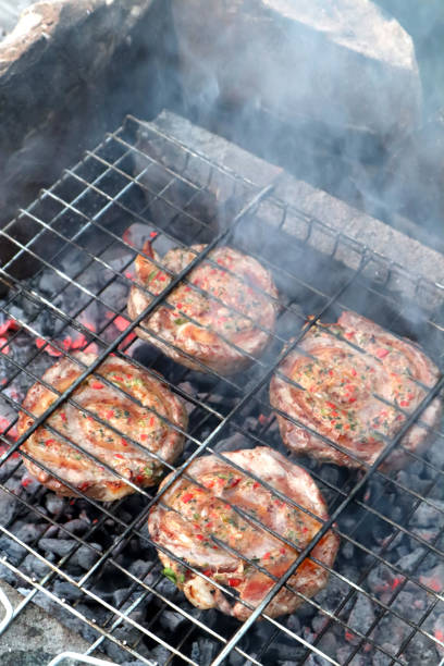 Juicy ground beef and steak wrap kebab on a hot grill.