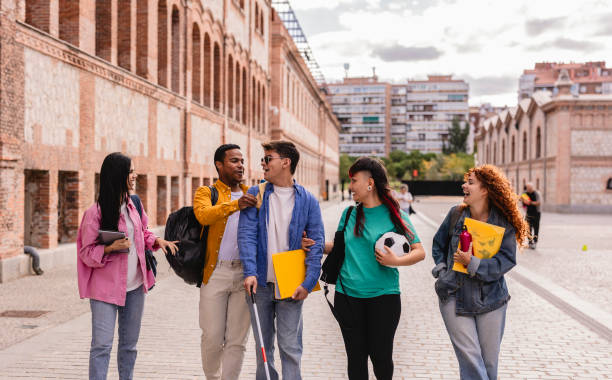istock Diverse group of students walking and talking on campus 2198852891