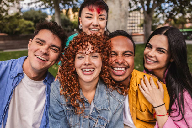 istock Group of young adults smiling together in a park 2198852896