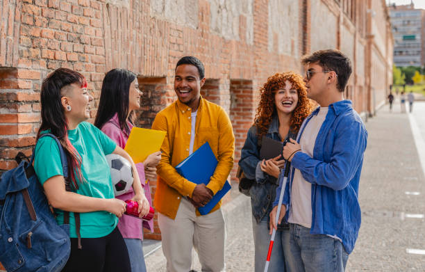 istock Happy diverse university students talking and laughing together outdoors 2198852969