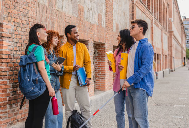 istock Visually impaired student talking with friends at university campus 2198853013