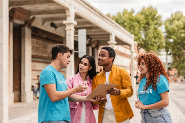 istock Volunteers discussing notes on clipboard outdoors 2198853237