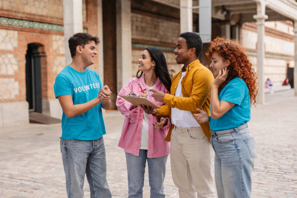 istock Volunteers discussing notes outdoors during charity event 2198853250