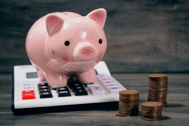 istock piggy bank on calculator and coins 2198863177