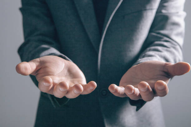 istock young businessman holding open palm 2198865019