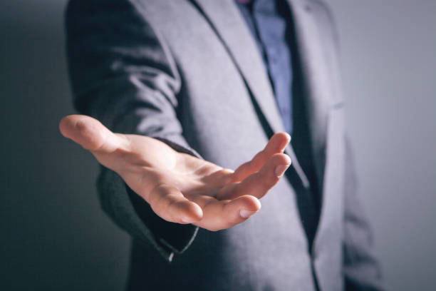 istock young businessman holding open palm 2198865031