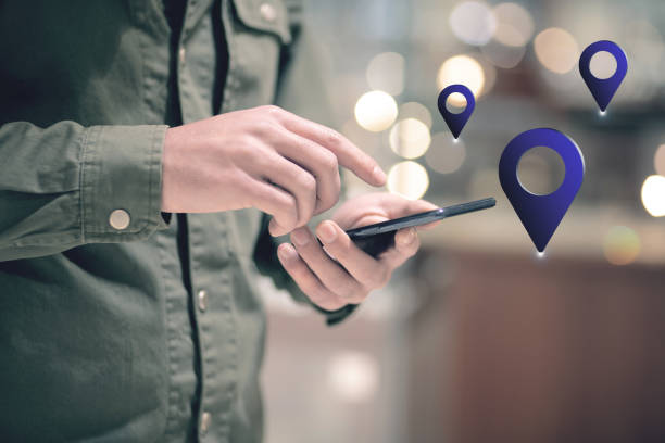 istock gps icon. man holding a phone in his hand 2198865077