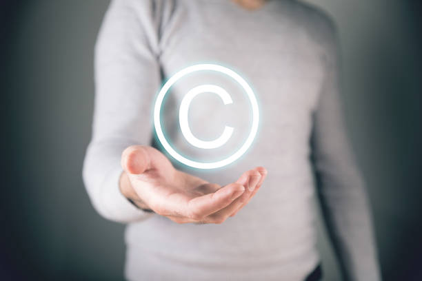 istock Intellectual property icon. Man holding in his hand 2198865101