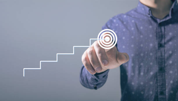 istock the ladder rises to the goal. man tapping on the screen 2198865165