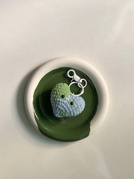 Handmade crochet keychain with intricate stitching and a soft, textured design. A cute and stylish accessory, perfect for adding a personal touch to your keys or bag.