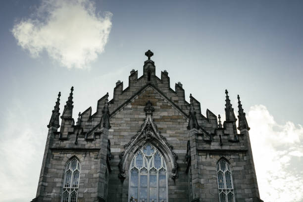 DUBLIN, IRELAND - SEPTEMBER 18, 2018: Close-up of the Gothic-style chapel facade at Dublin Castle, featuring pointed arches and intricate stone carvings.