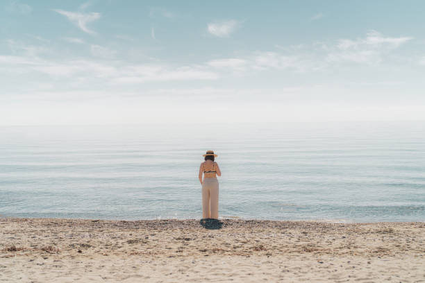 istock Woman by the sea 2198866419