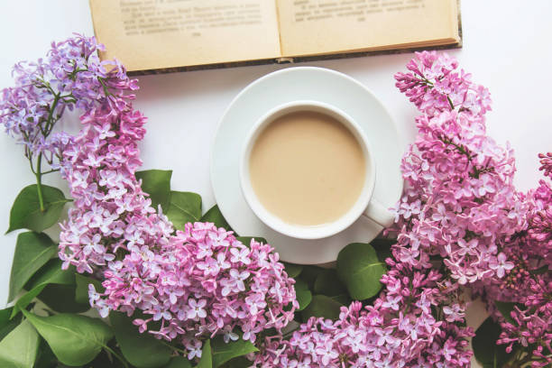 istock spring cozy composition flat lay coffee cup, book, lilac branches, spring season concept 2198866822