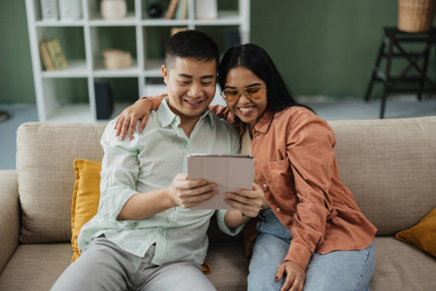 istock Couple Bonding with Tablet in Cozy Living Room 2198869364